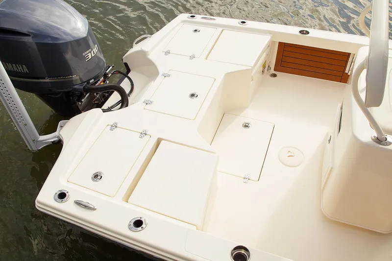 Slide: The Image of Manufacturer Provided Image: 2026 Pathfinder 2500 Hybrid boat deck with Yamaha engine, featuring storage compartments and seating area. - 34