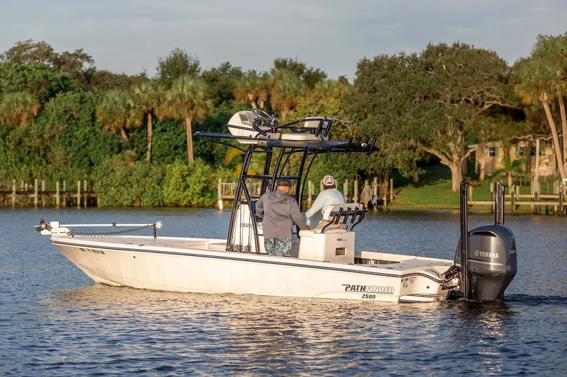 Slide: The Image of Manufacturer Provided Image: 2026 Pathfinder 2500 Hybrid boat cruising on a scenic lake with lush greenery. - 26