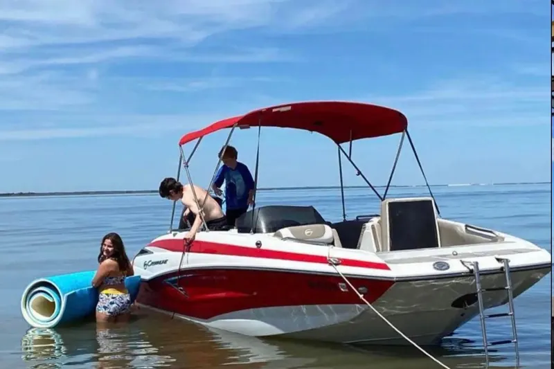 Slide: The Image of 2021 Crownline Eclipse E205 XS boat with people enjoying water activities. - 4