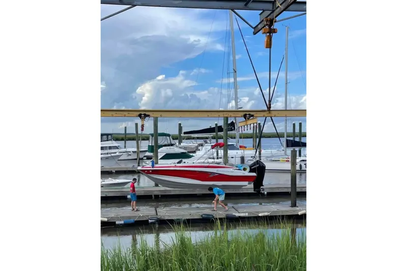The Image of 2021 Crownline Eclipse E205 XS boat docked at a marina with people nearby. - 6