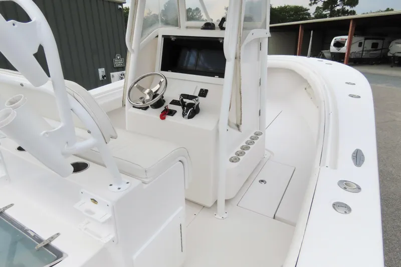 Slide: The Image of 2008 Onslow Bay 27 Offshore Edition boat interior with steering console and seating. - 17