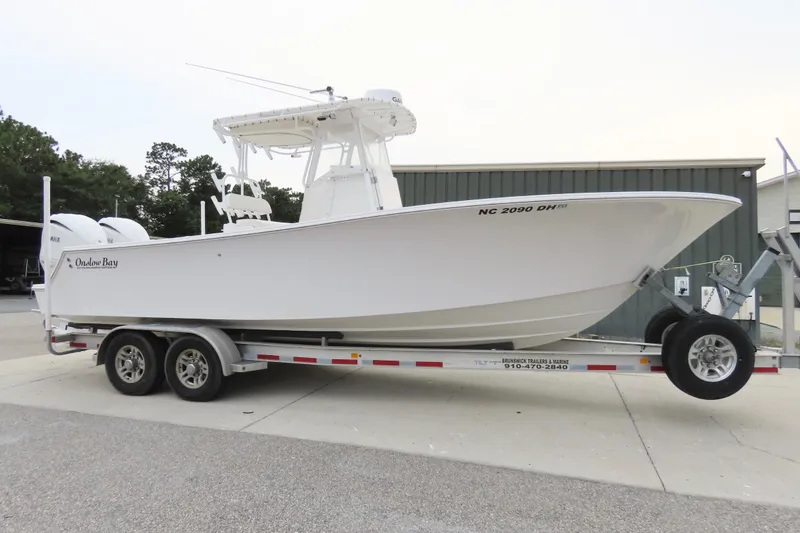 Slide: The Image of 2008 Onslow Bay 27 Offshore Edition boat on trailer, parked outdoors. - 2