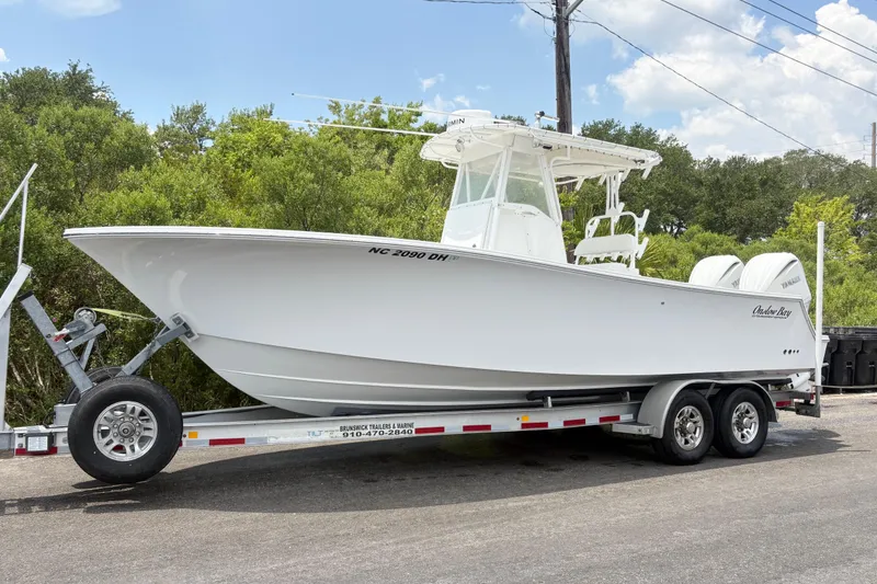 The Image of 2008 Onslow Bay 27 Offshore Edition boat on trailer, parked outdoors. - 1