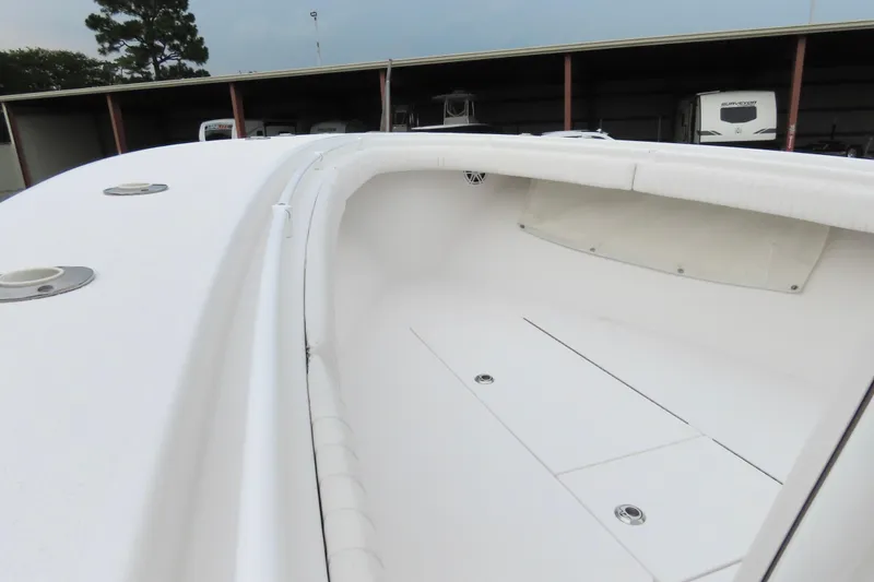 Slide: The Image of 2008 Onslow Bay 27 Offshore Edition boat interior, showcasing spacious white deck and storage compartments. - 18