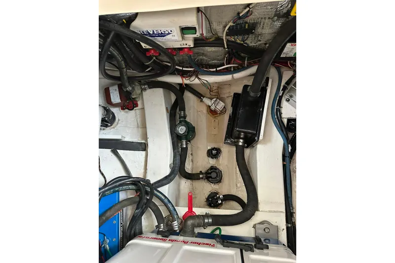 Slide: The Image of Engine compartment of a 2007 True North 38 Heritage boat, showcasing wiring and mechanical components. - 94