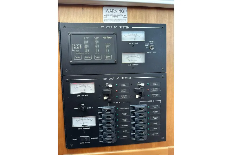 Slide: The Image of Electrical panel of a 2007 True North 38 Heritage boat, featuring 12V and 120V systems. - 76