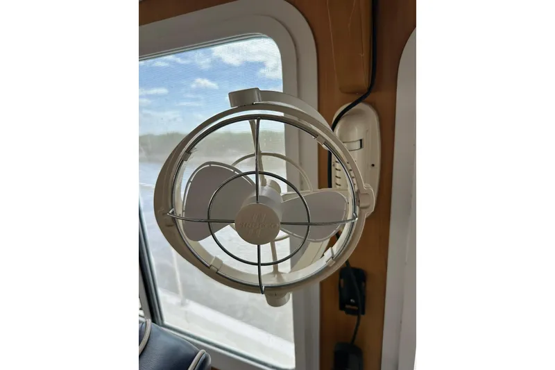 Slide: The Image of Wall-mounted fan inside 2007 True North 38 Heritage boat, near window with scenic view. - 110