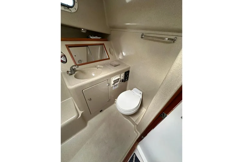 Slide: The Image of Compact bathroom in 2007 True North 38 Heritage boat with sink, mirror, and toilet. - 83