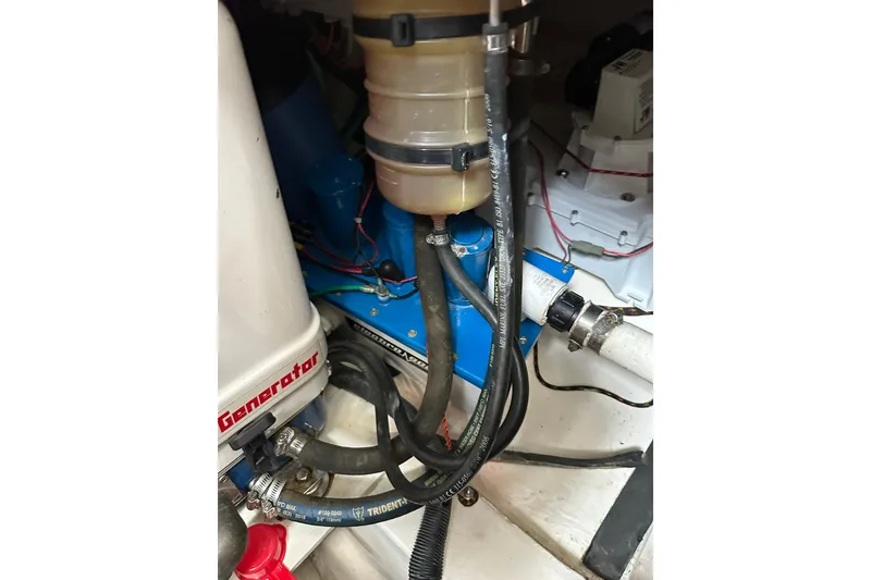 Slide: The Image of Engine compartment of 2007 True North 38 Heritage boat, showing generator and hoses. - 97