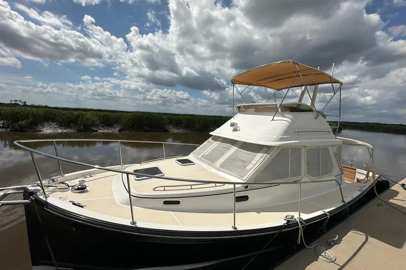 Slide: The Image of 2007 True North 38 Heritage yacht docked under a cloudy sky. - 11