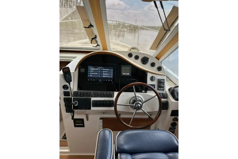 Slide: The Image of Helm of 2007 True North 38 Heritage boat with steering wheel and navigation controls. - 68