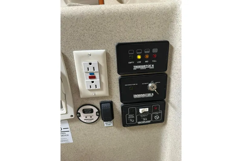 Slide: The Image of Control panel of a 2007 True North 38 Heritage boat with electrical outlets and monitoring systems. - 84