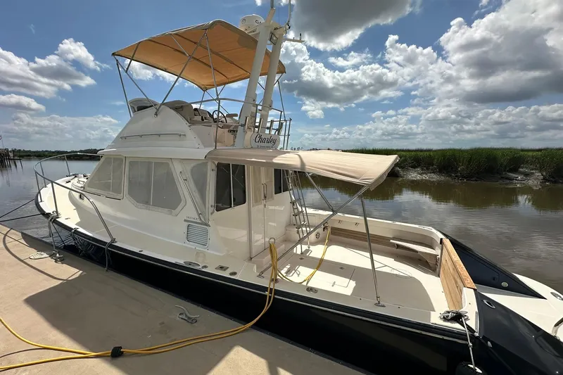 Slide: The Image of 2007 True North 38 Heritage yacht docked under a partly cloudy sky. - 9