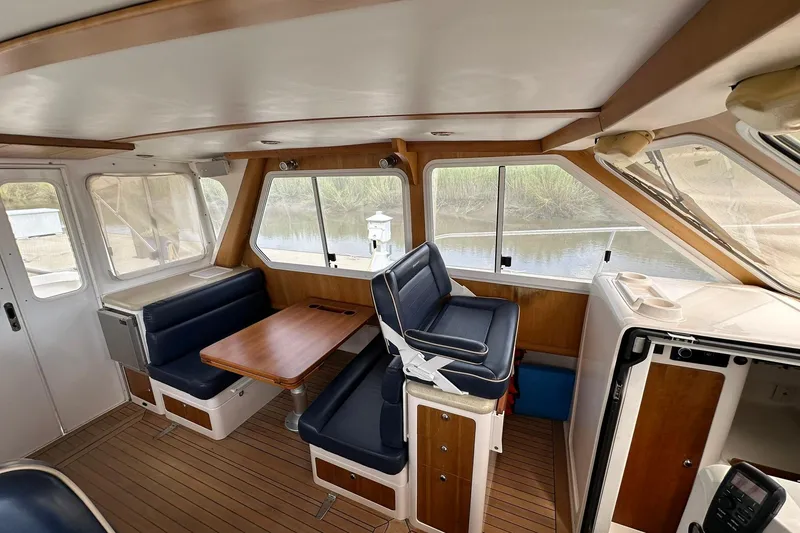 Slide: The Image of 2007 True North 38 Heritage boat interior with seating and wooden table. - 59