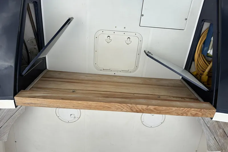 Slide: The Image of Wooden platform on a 2007 True North 38 Heritage boat with storage compartments. - 19