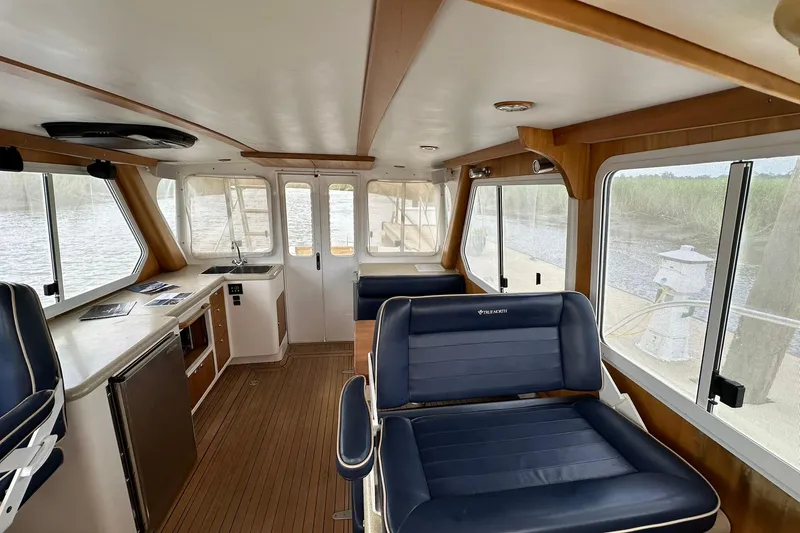 Slide: The Image of Interior of 2007 True North 38 Heritage boat with seating and kitchenette, overlooking water. - 89