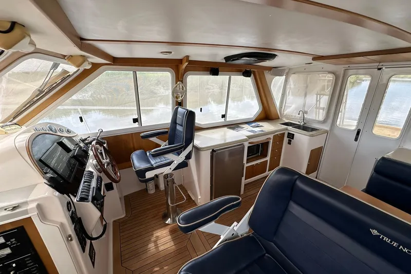 Slide: The Image of Interior of 2007 True North 38 Heritage boat with helm, seating, and kitchenette. - 60