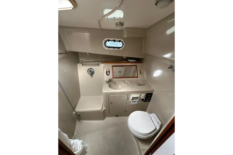 Slide: The Image of Compact bathroom in 2007 True North 38 Heritage yacht with sink, toilet, and mirror. - 81