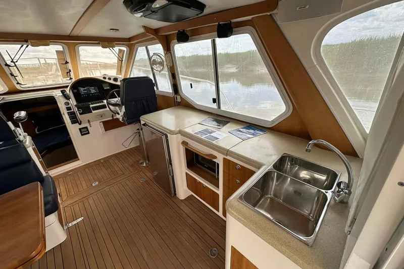 Slide: The Image of Interior of 2007 True North 38 Heritage boat with helm, seating, and kitchenette. - 54