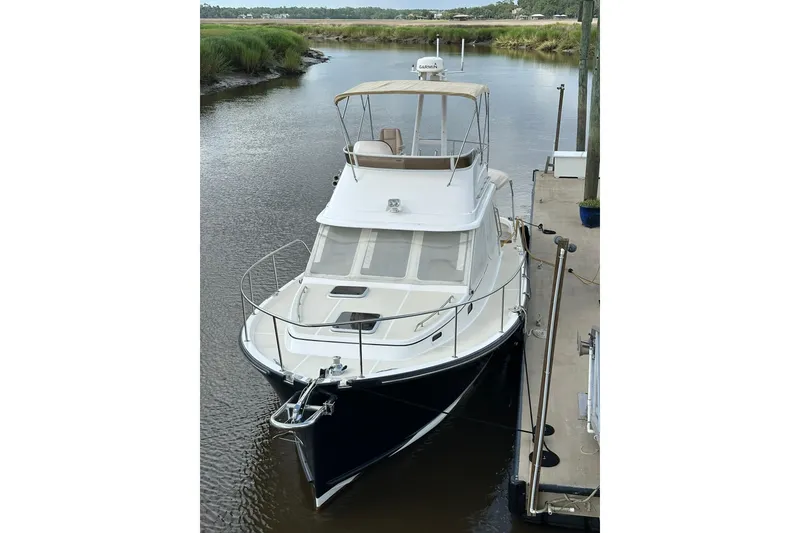 Slide: The Image of 2007 True North 38 Heritage yacht docked in a serene waterway. - 122