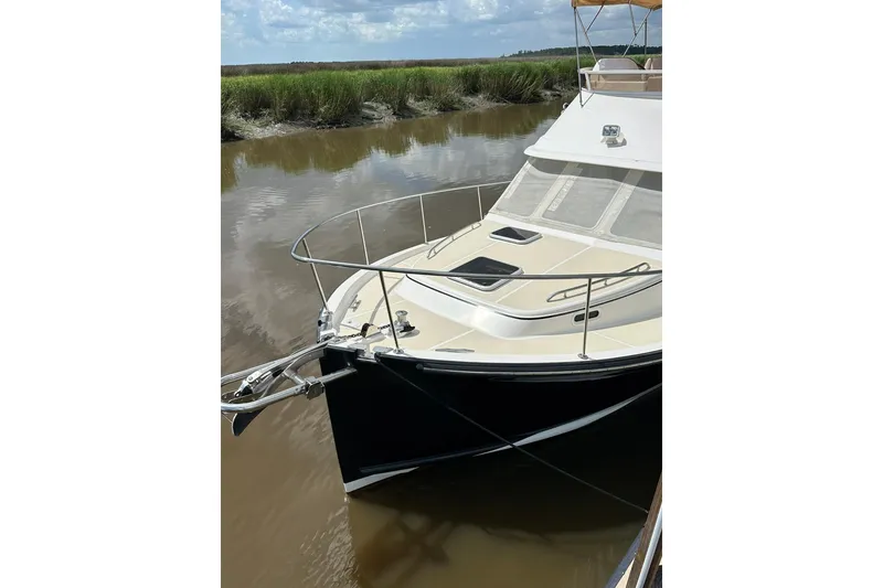 Slide: The Image of 2007 True North 38 Heritage yacht docked on calm water. - 2