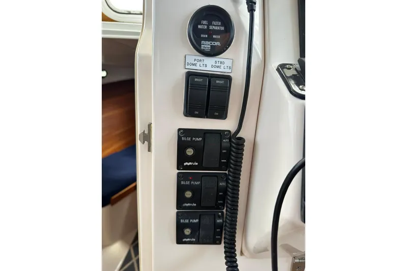 Slide: The Image of Control panel of a 2007 True North 38 Heritage boat with bilge pump switches. - 72