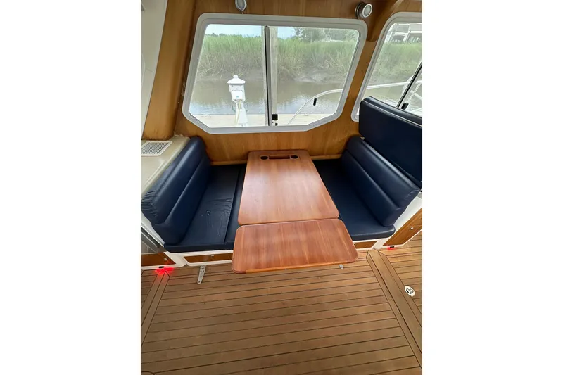 Slide: The Image of Interior of 2007 True North 38 Heritage boat with wooden table and blue seating. - 108