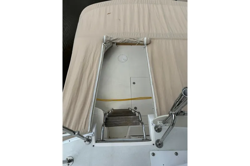 Slide: The Image of 2007 True North 38 Heritage boat with covered deck and wooden steps. - 48