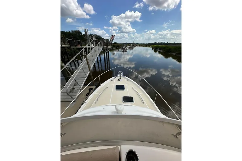 Slide: The Image of Bow view of 2007 True North 38 Heritage yacht on calm water under blue sky. - 46