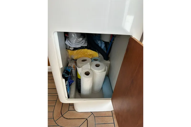 Slide: The Image of Storage compartment on 2007 True North 38 Heritage boat with paper towels and supplies. - 121