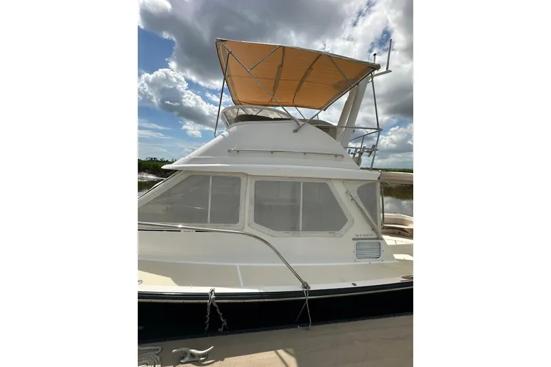 Slide: The Image of 2007 True North 38 Heritage yacht with canopy under cloudy sky. - 7