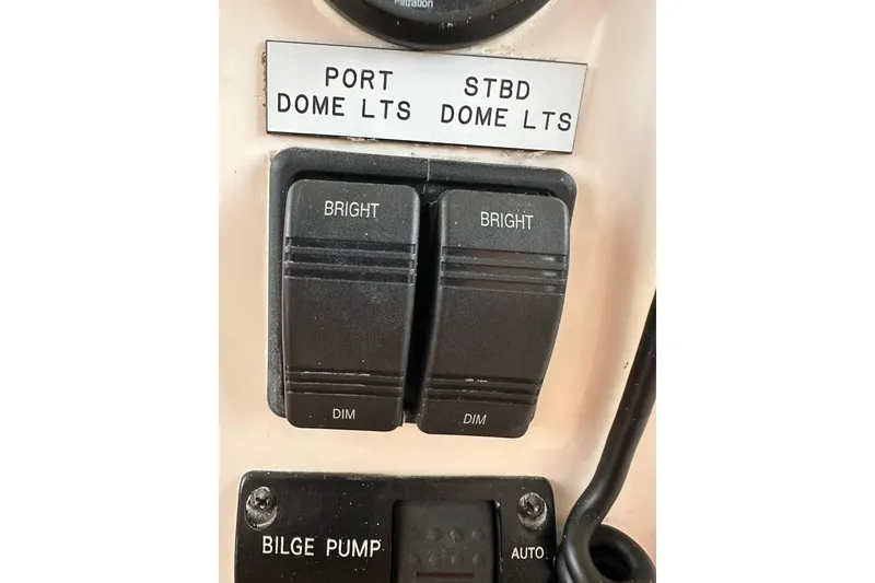 Slide: The Image of Control panel of a 2007 True North 38 Heritage boat with dome light switches. - 115