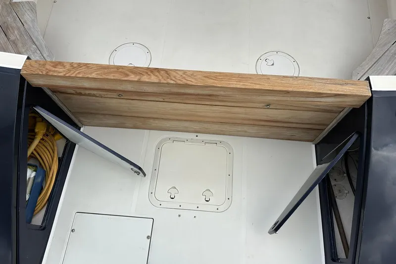 Slide: The Image of Wooden platform on a 2007 True North 38 Heritage boat with storage compartments. - 19