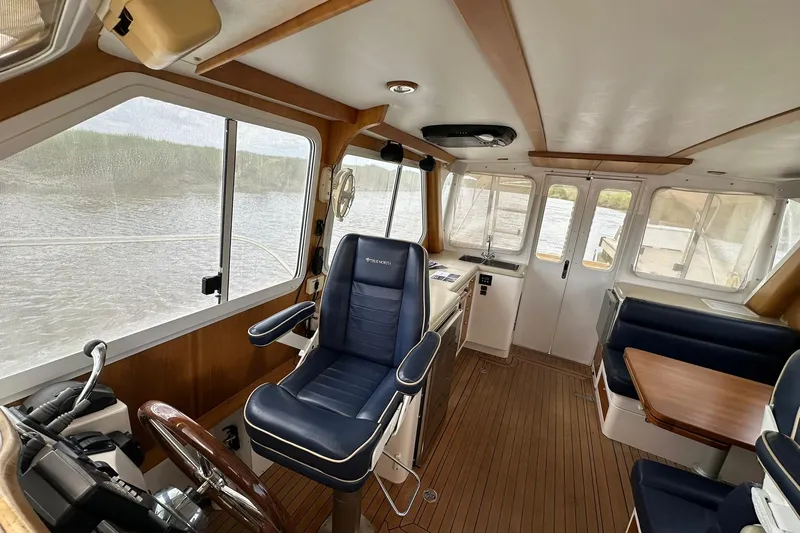 Slide: The Image of Interior of 2007 True North 38 Heritage boat with helm, seating, and wood accents. - 90