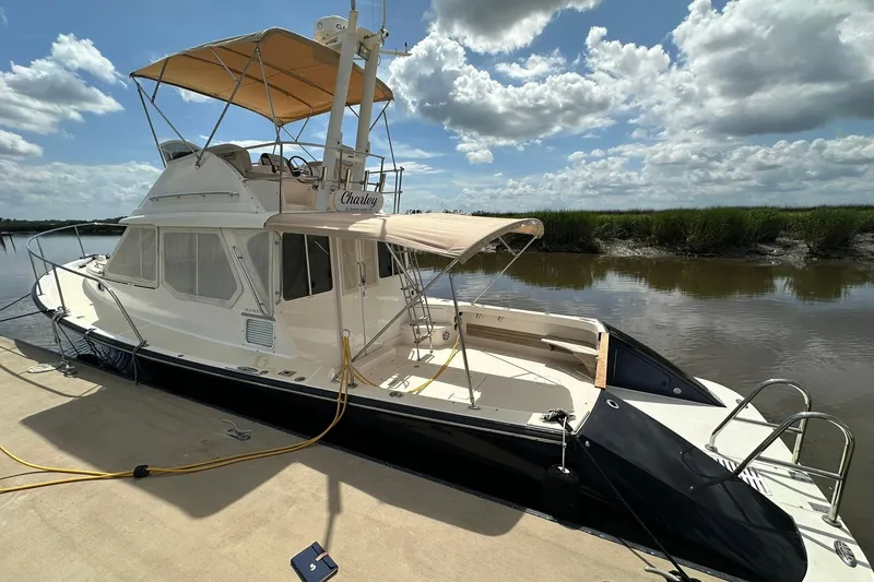 Slide: The Image of 2007 True North 38 Heritage yacht docked under a partly cloudy sky. - 10