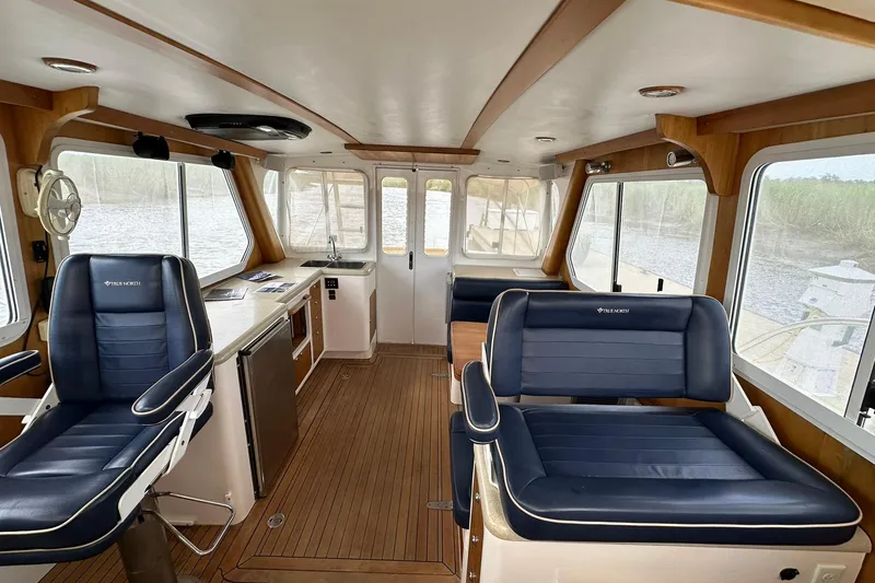 Slide: The Image of Interior of a 2007 True North 38 Heritage boat with sleek seating and wooden accents. - 88