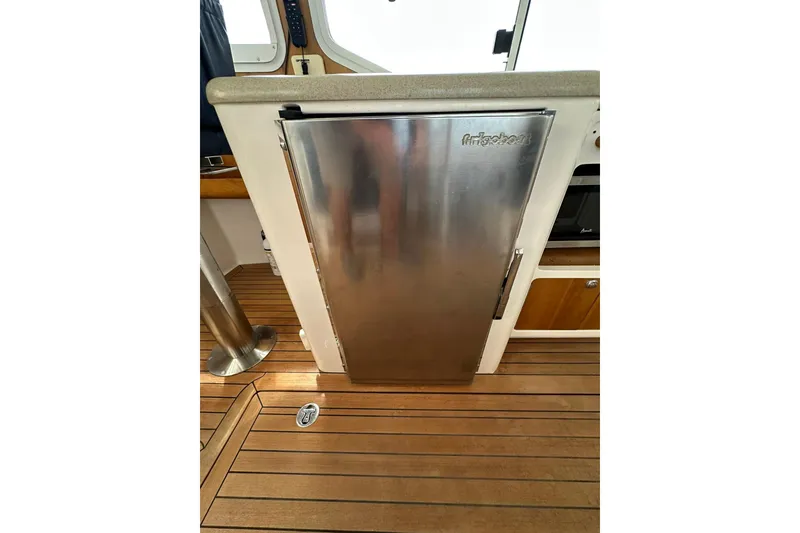 Slide: The Image of Stainless steel fridge on 2007 True North 38 Heritage yacht with wooden flooring. - 61
