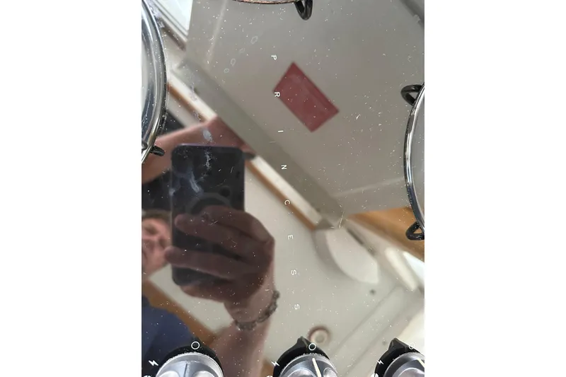 Slide: The Image of Reflection on a glossy surface with a person holding a phone, True North 38 Heritage 2007. - 67
