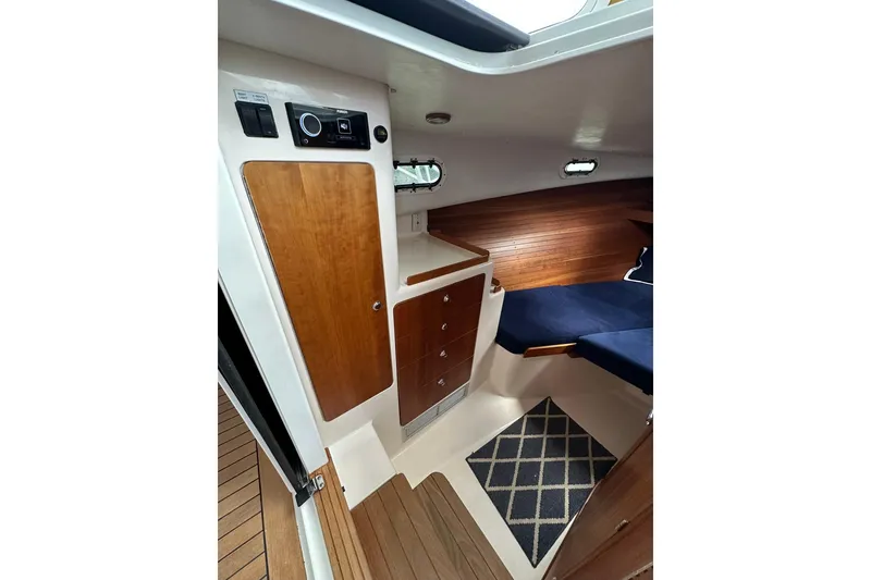 Slide: The Image of Cozy cabin interior of 2007 True North 38 Heritage yacht with wood accents and blue seating. - 75