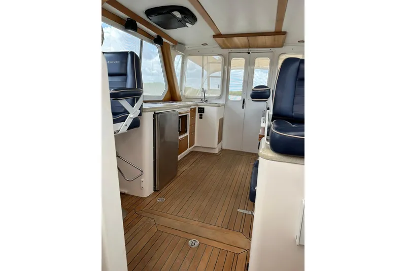 Slide: The Image of Interior of 2007 True North 38 Heritage boat with wood flooring and seating. - 87