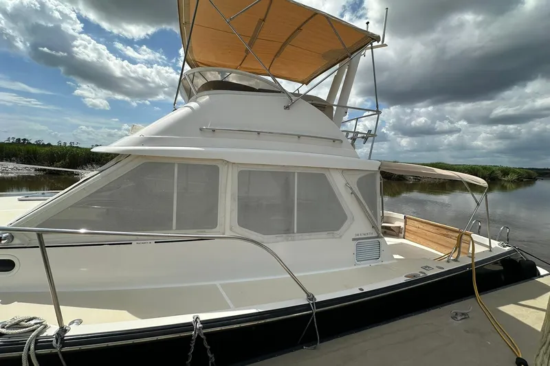 Slide: The Image of 2007 True North 38 Heritage yacht docked under cloudy sky. - 8
