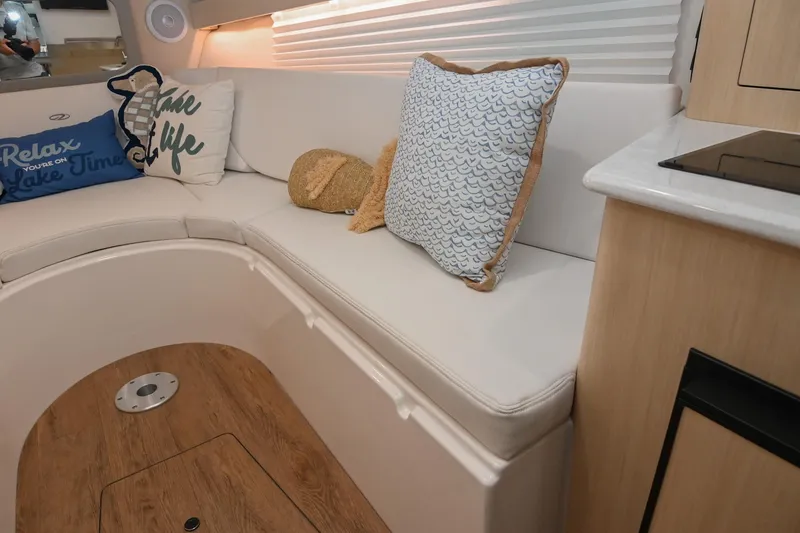 Slide: The Image of Interior of 2025 Regal 28 Express boat with cozy seating and decorative pillows. - 46