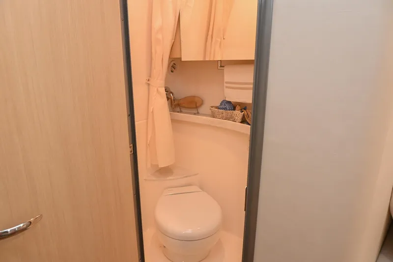 Slide: The Image of 2025 Regal 28 Express boat bathroom with toilet and shower curtain. - 51