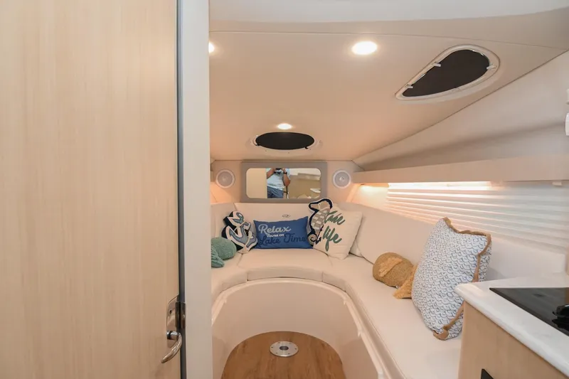 Slide: The Image of Interior of 2025 Regal 28 Express boat with cozy seating and decorative pillows. - 41