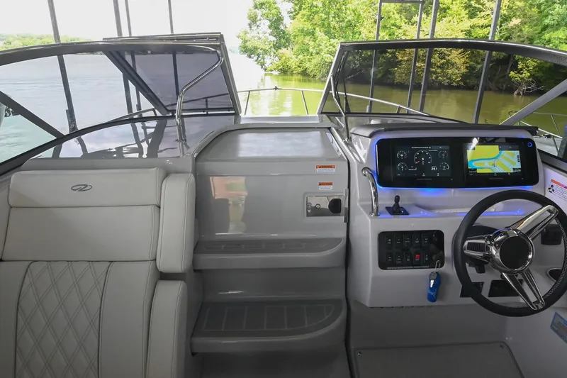 Slide: The Image of 2025 Regal 28 Express boat cockpit with modern dashboard and steering wheel. - 32