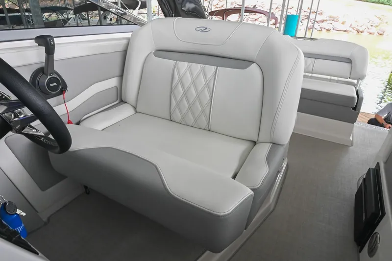 Slide: The Image of 2025 Regal 28 Express boat interior with luxurious seating and modern steering controls. - 31