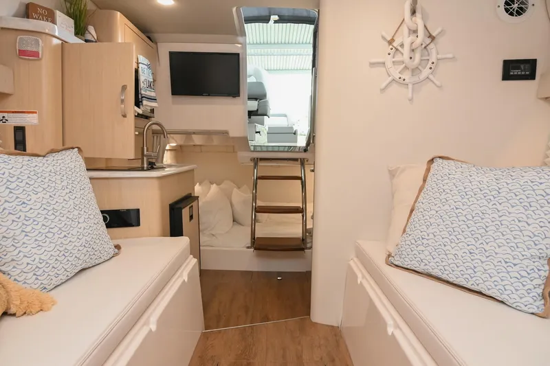 Slide: The Image of Interior of 2025 Regal 28 Express boat, featuring cozy seating and modern amenities. - 48