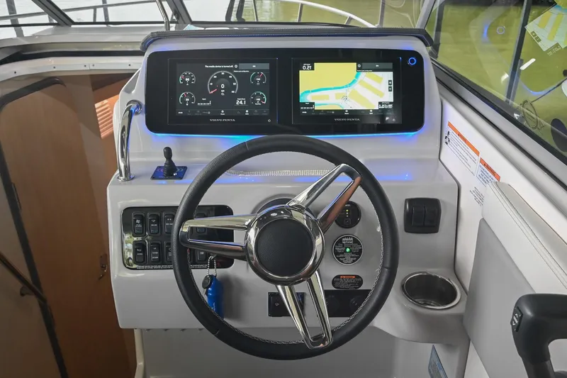 Slide: The Image of 2025 Regal 28 Express boat dashboard with modern controls and navigation screens. - 26