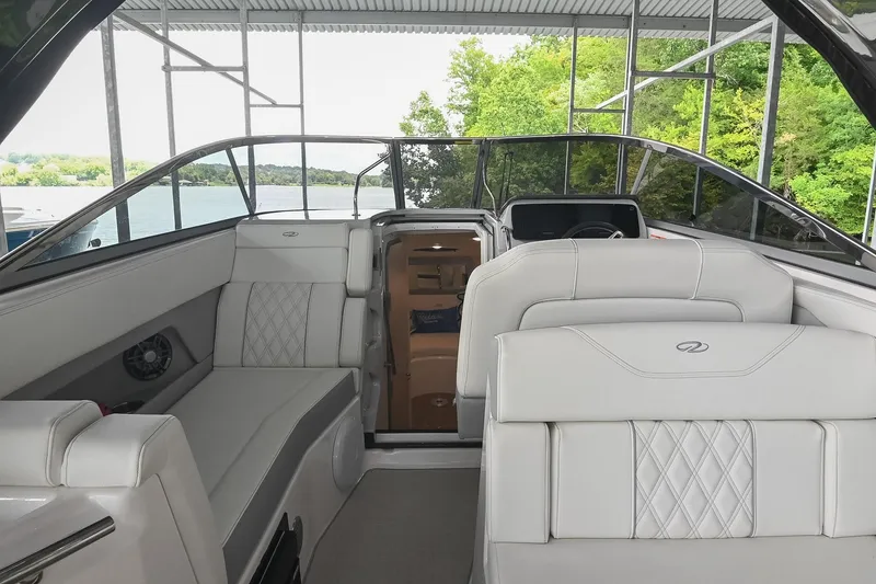 Slide: The Image of 2025 Regal 28 Express boat interior with luxurious seating and scenic lake view. - 20