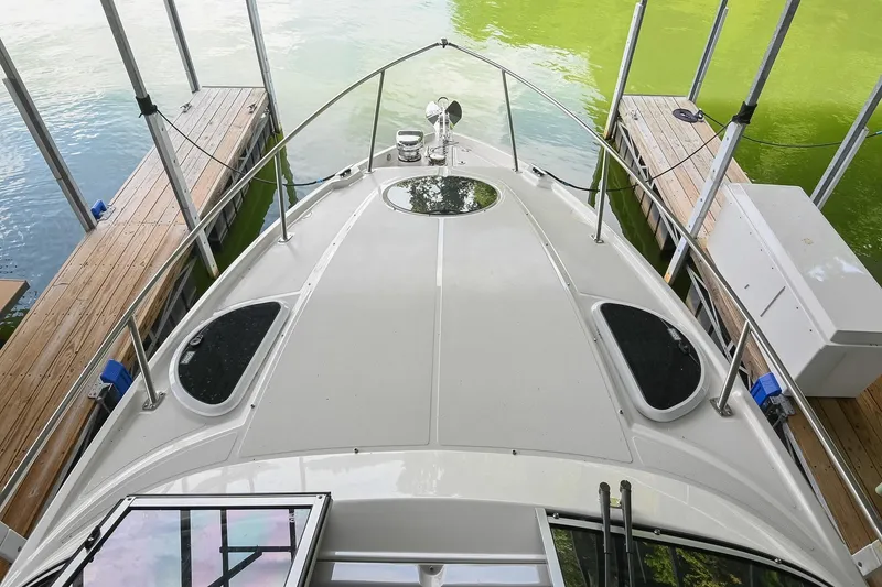 Slide: The Image of 2025 Regal 28 Express boat docked, showcasing sleek deck design and modern features. - 33